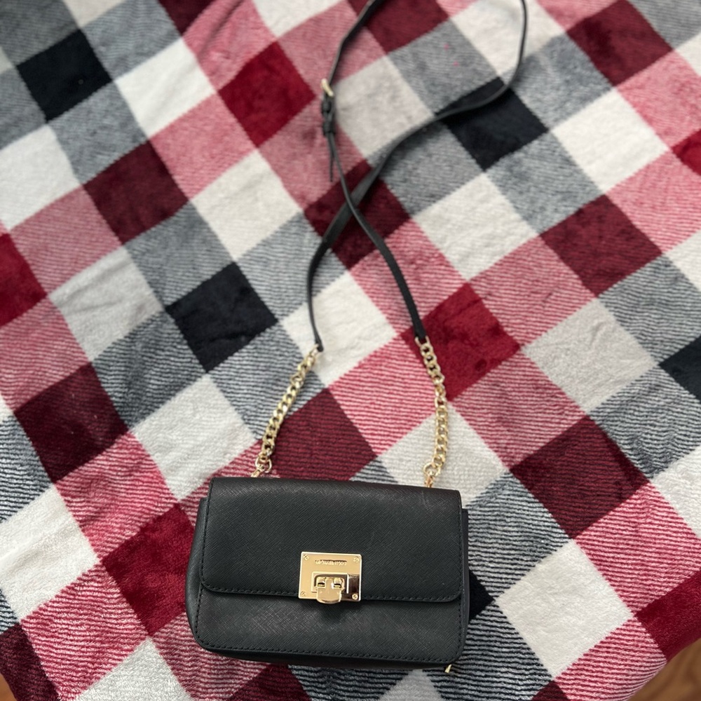 Classy Michael Kors black handbag with gold hardware and chain strap.